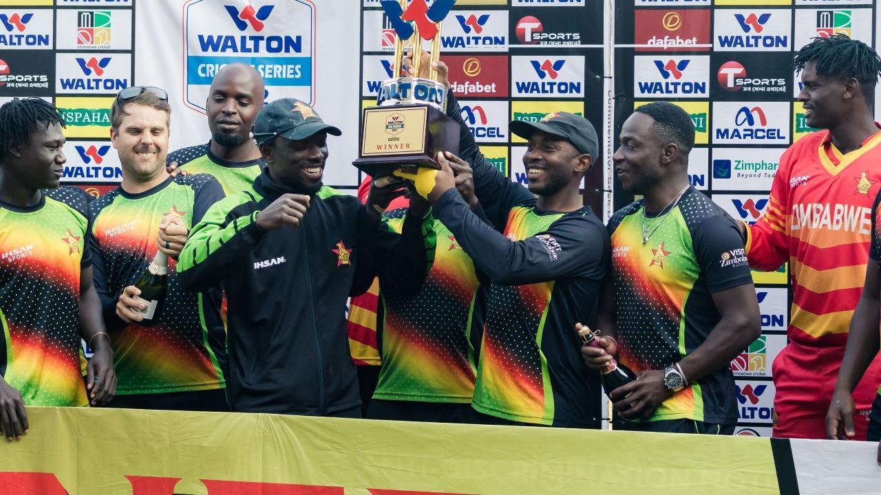 Zimbabwe players hold the trophy as they celebrate the series victory following the third ODI match between Zimbabwe and Bangladesh. Pic/ AFP